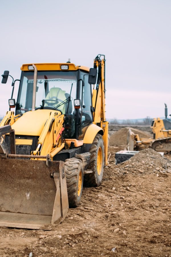 Industrial backhoe excavator loader and bulldozer machinery on construction site